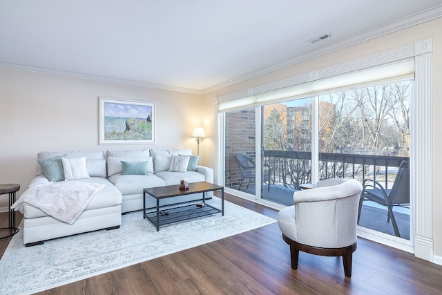 living room featuring dark hardwood / wood-style floors and crown molding