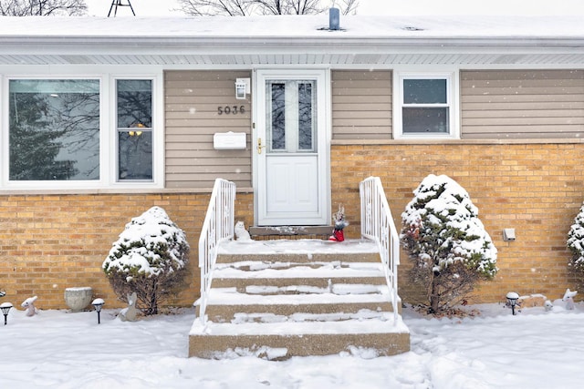 view of snow covered property entrance