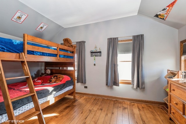 bedroom with wood-type flooring and lofted ceiling