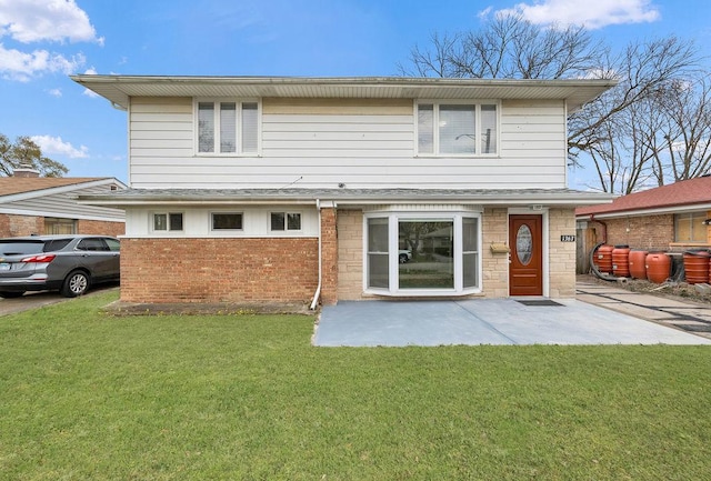 back of property featuring a lawn and a patio