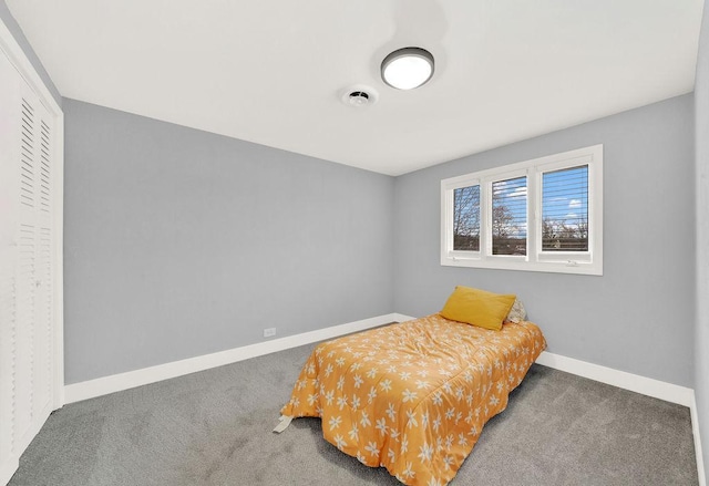 bedroom featuring dark carpet and a closet