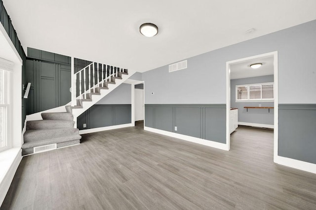 unfurnished living room featuring hardwood / wood-style floors and a wealth of natural light