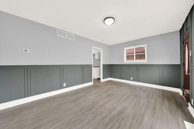 empty room with hardwood / wood-style floors