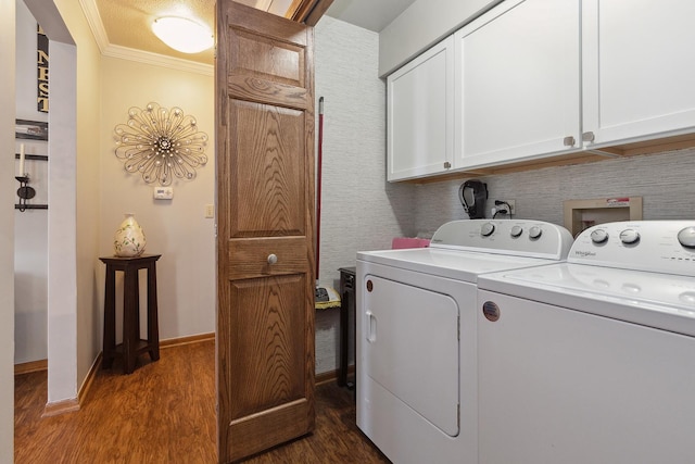 washroom with cabinets, washer and dryer, ornamental molding, and dark hardwood / wood-style floors