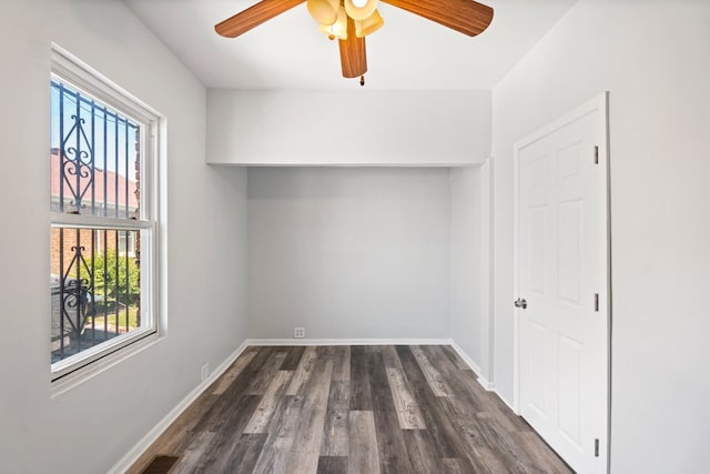 interior space with plenty of natural light, dark wood-type flooring, and ceiling fan