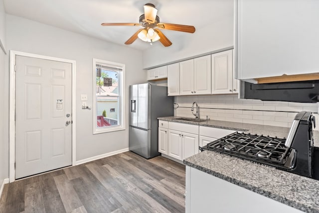 kitchen featuring decorative backsplash, sink, hardwood / wood-style flooring, stainless steel fridge with ice dispenser, and white cabinetry