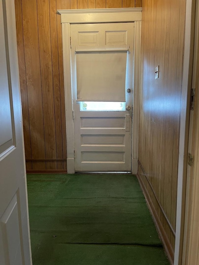 entryway with wood walls