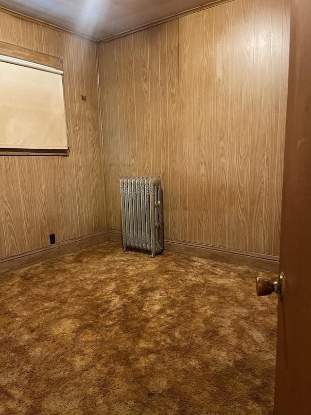 empty room with carpet and radiator