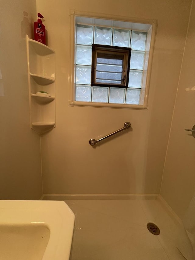 bathroom with tile patterned floors and a shower