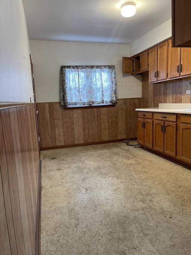 kitchen featuring wood walls