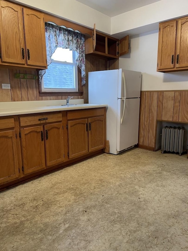 kitchen with radiator and white refrigerator