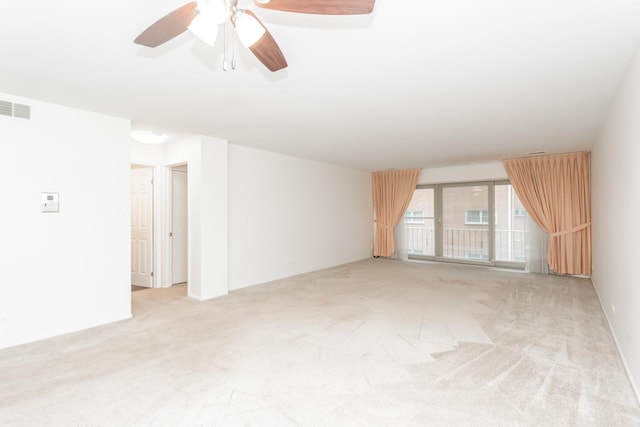 carpeted spare room featuring ceiling fan