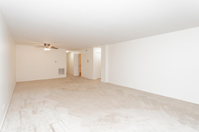 empty room featuring light colored carpet and ceiling fan