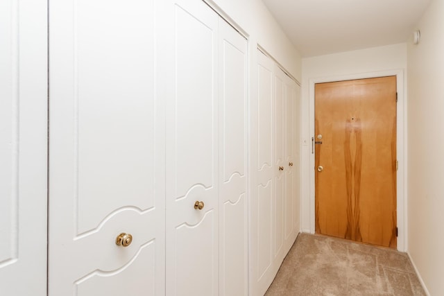 hall featuring light colored carpet