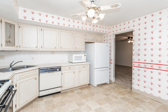 kitchen featuring decorative backsplash, white appliances, and sink