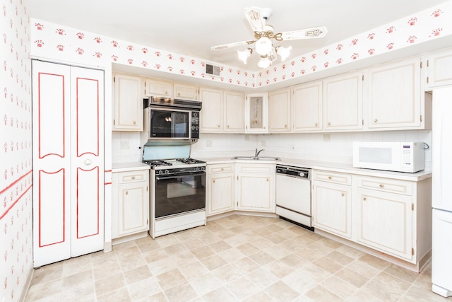 kitchen with decorative backsplash, ceiling fan, sink, and white appliances