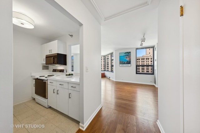 kitchen with white cabinetry and white range with electric cooktop