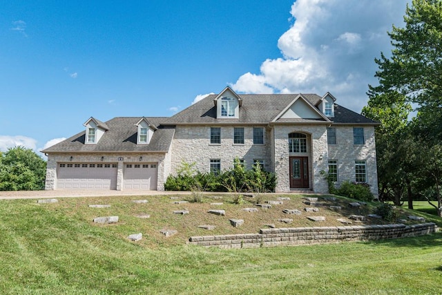 view of front of home with a front yard and a garage