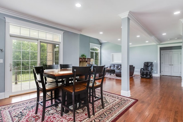 dining area with dark hardwood / wood-style flooring and ornamental molding