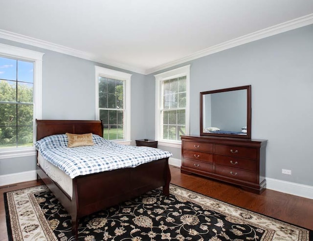 bedroom with hardwood / wood-style floors, multiple windows, and ornamental molding