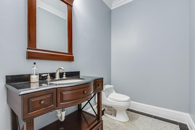 bathroom with crown molding, vanity, and toilet