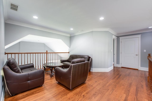 living room featuring hardwood / wood-style flooring and crown molding