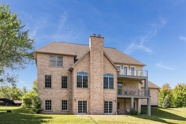 back of property featuring a yard and a balcony