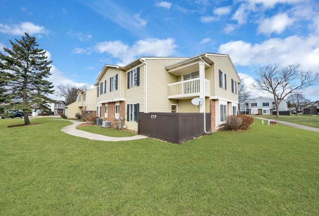 view of side of property with a lawn and cooling unit