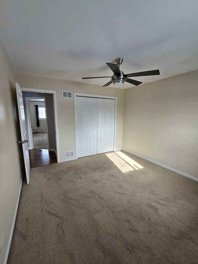 unfurnished bedroom with ceiling fan and carpet