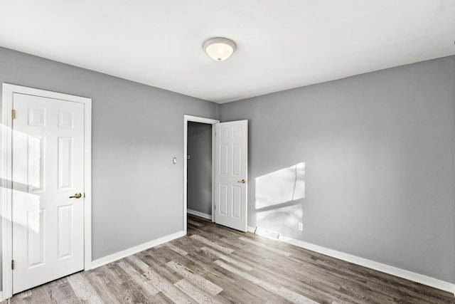 unfurnished bedroom with light hardwood / wood-style floors