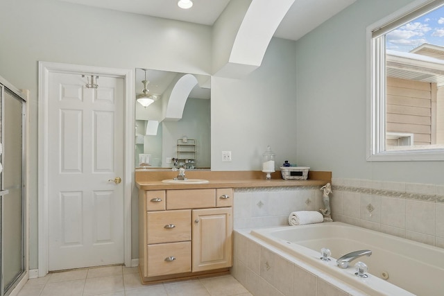 bathroom with tile patterned flooring, vanity, and separate shower and tub