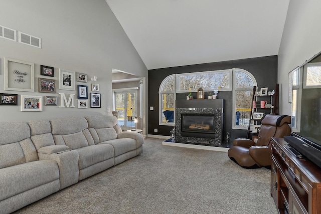 carpeted living room featuring high vaulted ceiling