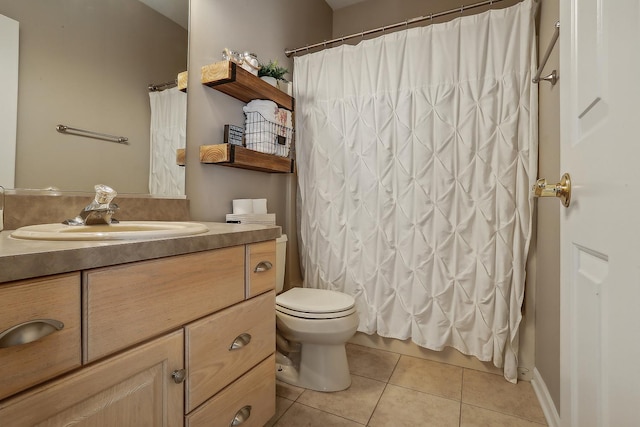 bathroom with toilet, vanity, tile patterned floors, and walk in shower