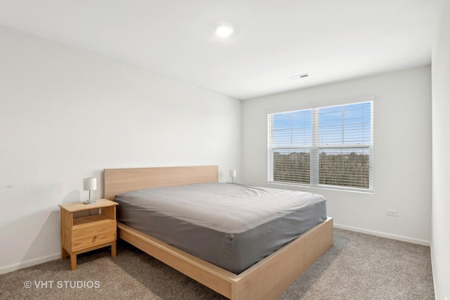 bedroom with light colored carpet