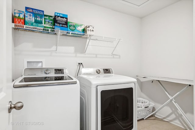 laundry area featuring washer and dryer and tile patterned flooring