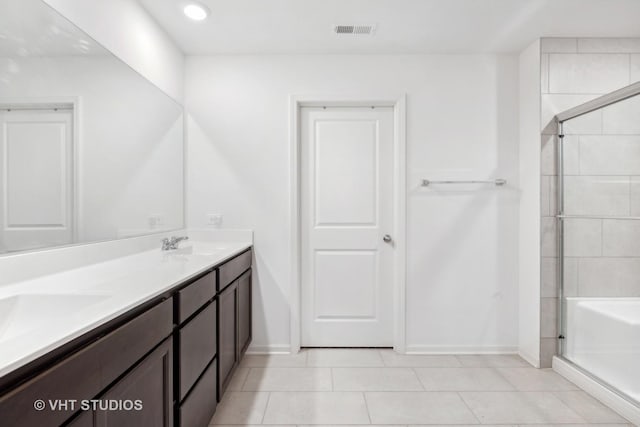 bathroom featuring tile patterned flooring, vanity, and an enclosed shower