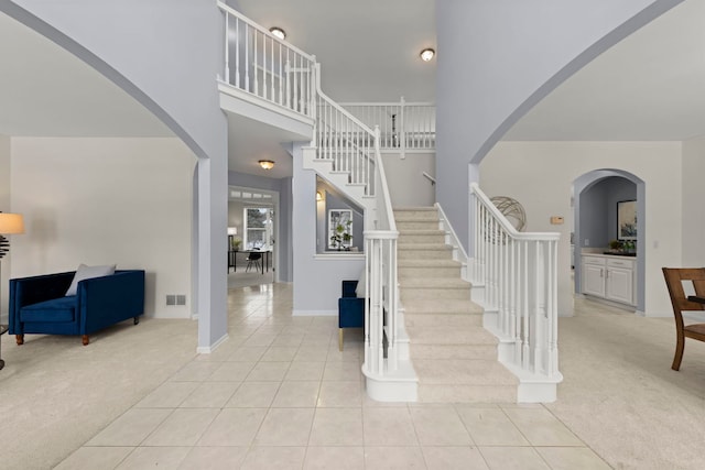 stairway featuring carpet