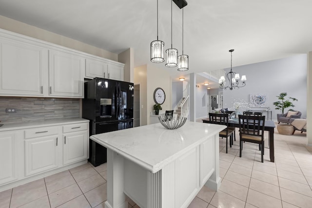 kitchen featuring white cabinets, a notable chandelier, light tile patterned floors, and a center island