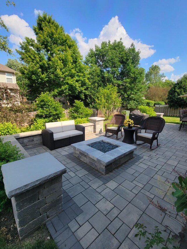 view of patio featuring an outdoor living space with a fire pit