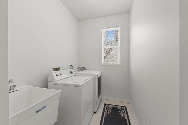 kitchen featuring light tile patterned floors, decorative light fixtures, black appliances, white cabinets, and a center island