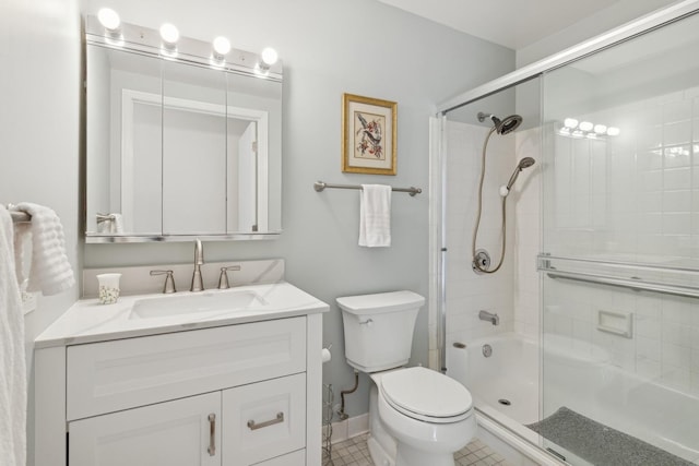 full bathroom featuring toilet, vanity, tile patterned flooring, and enclosed tub / shower combo