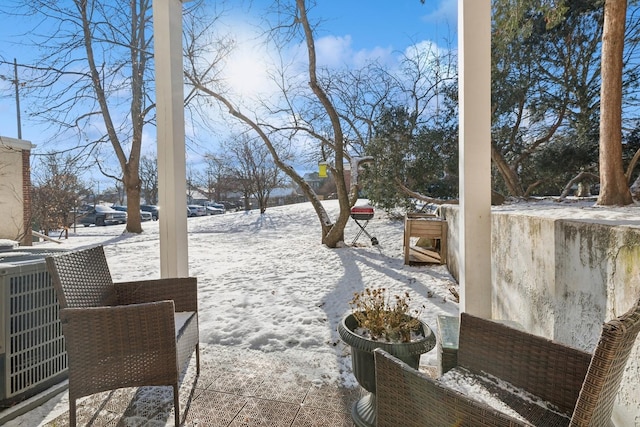 yard layered in snow with central AC