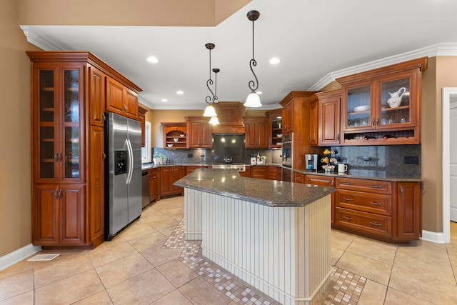 kitchen featuring dark stone countertops, custom exhaust hood, hanging light fixtures, a center island, and stainless steel appliances