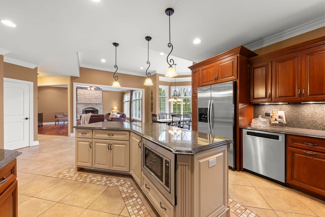 kitchen featuring pendant lighting, appliances with stainless steel finishes, dark stone countertops, and light tile patterned floors