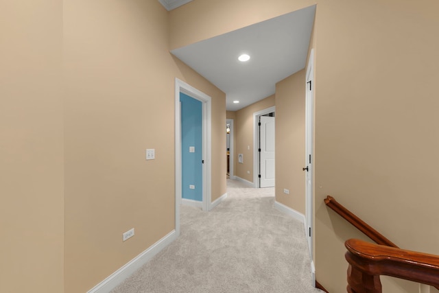 hall featuring light colored carpet