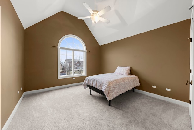 bedroom featuring high vaulted ceiling, light colored carpet, and ceiling fan