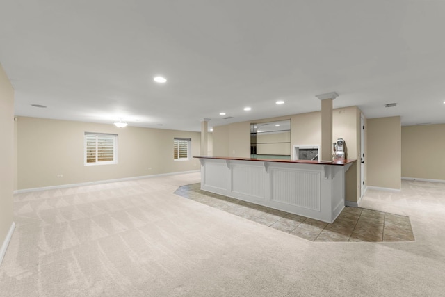 kitchen featuring light carpet and a breakfast bar