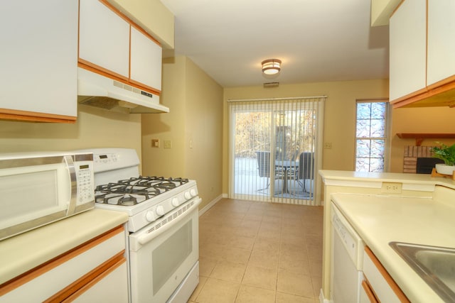 kitchen with sink, white cabinets, and white appliances