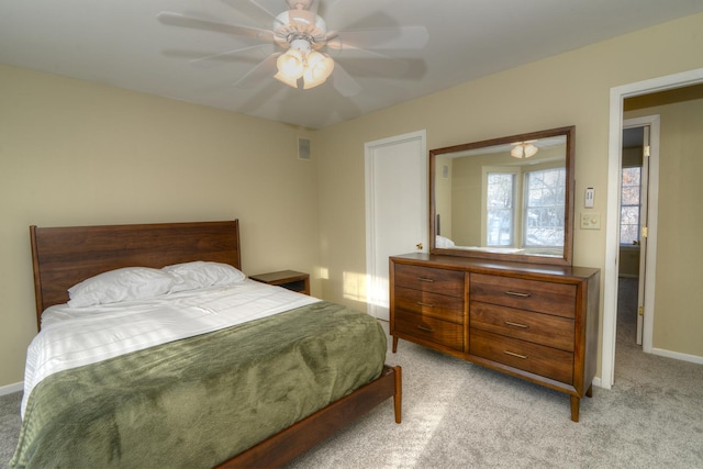 bedroom with ceiling fan and light carpet