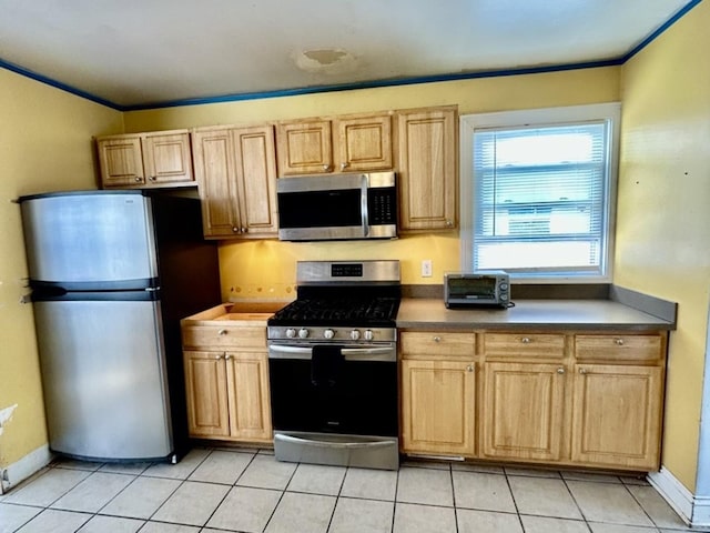 kitchen with crown molding, light brown cabinets, light tile patterned flooring, and appliances with stainless steel finishes